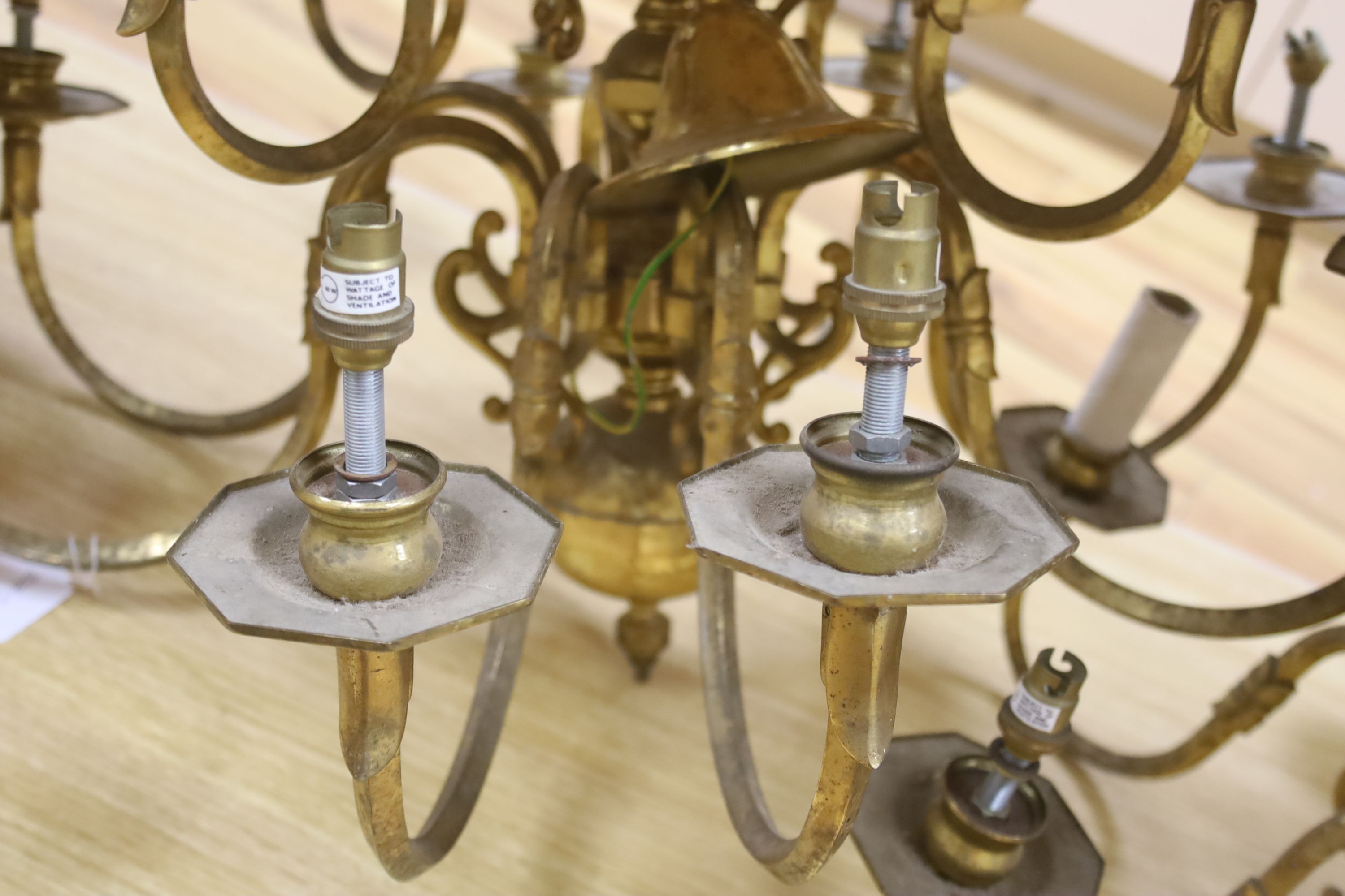 A brass two tier twelve branch electrolier and an associated six branch electrolier